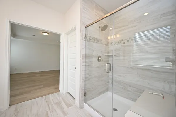 a bathroom with a bathtub a sink and a window