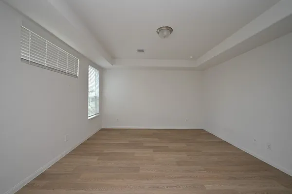 a view of a room with wooden floor and window