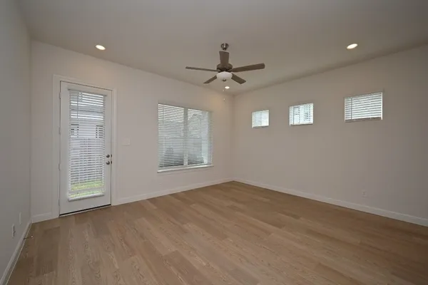 wooden floor in an empty room with a window
