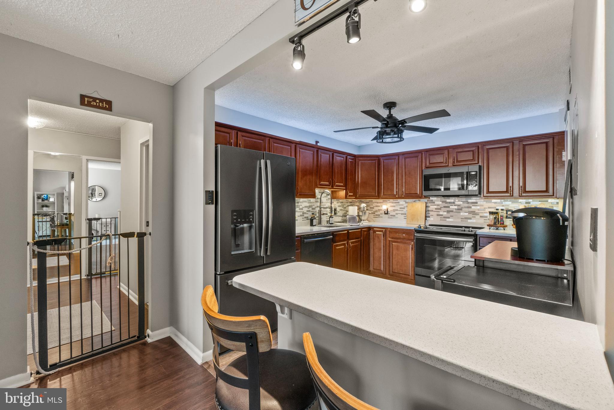 205 East Joppa Road, Unit 708 Baltimore, MD 21286 - Photo 13 of 35 quartz breakfast bar looking into the kitchen