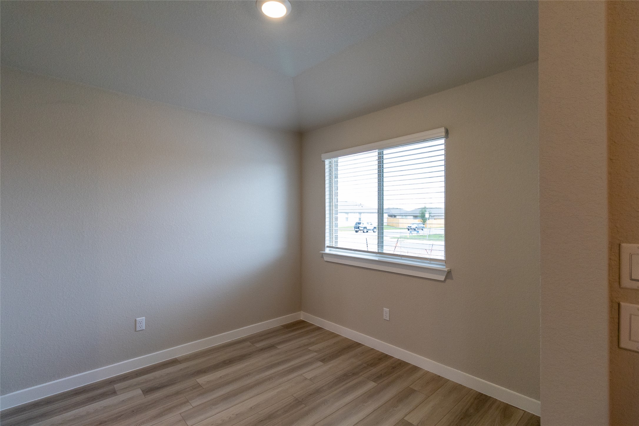 325 Coda Crossing Georgetown, TX 78633 - Photo 11 of 24 an empty room with wooden floor and windows