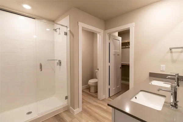 a bathroom with a shower sink and toilet
