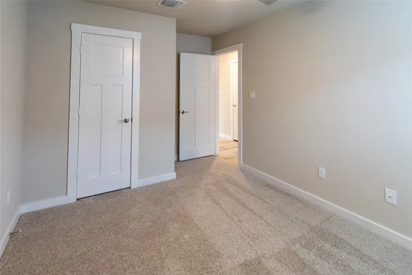 a view of an empty room and closet area