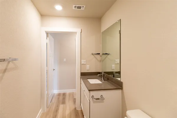 a bathroom with a sink a toilet and a mirror
