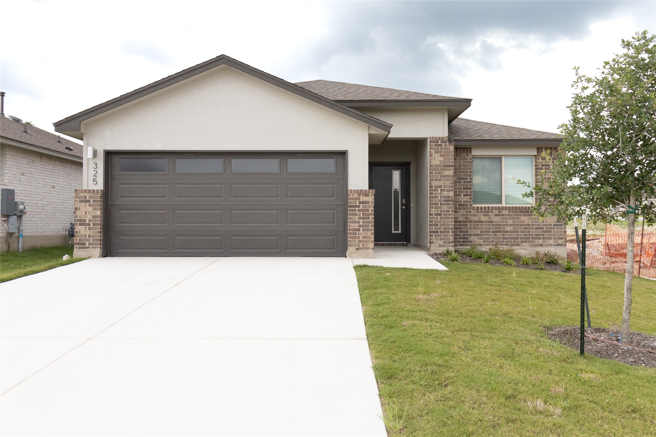 325 Coda Crossing Georgetown, TX 78633 - Photo 2 of 24 a front view of a house with garden