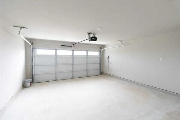 an empty room with a cabinet and mirrors