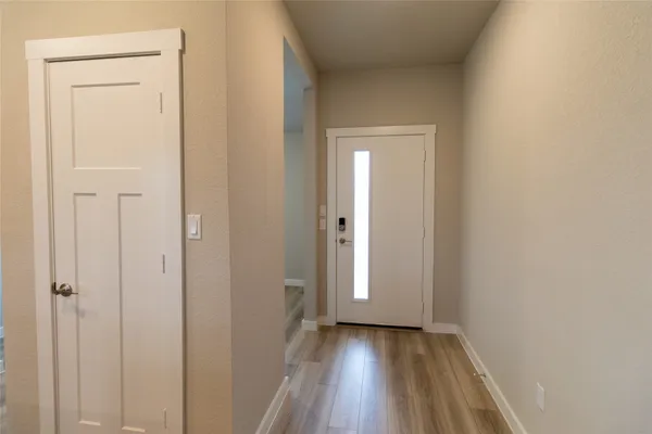 a view of a hallway with wooden floor