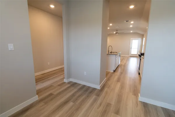 a view of a hallway with wooden floor