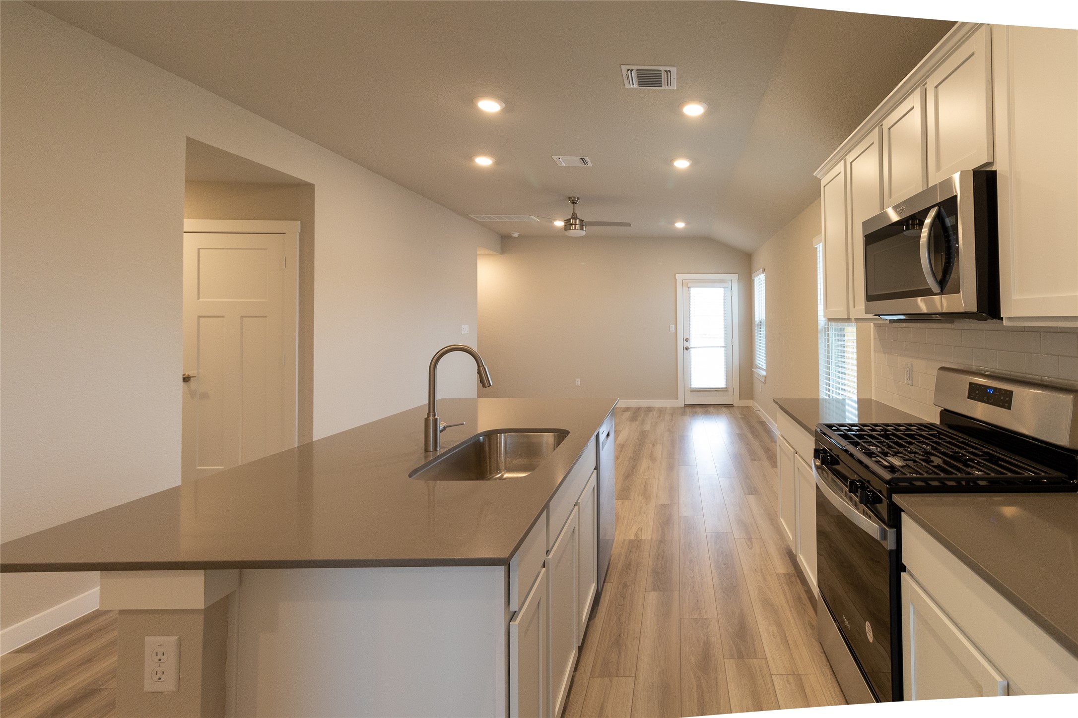 325 Coda Crossing Georgetown, TX 78633 - Photo 6 of 24 a view of a kitchen with kitchen island a sink stainless steel appliances and cabinets