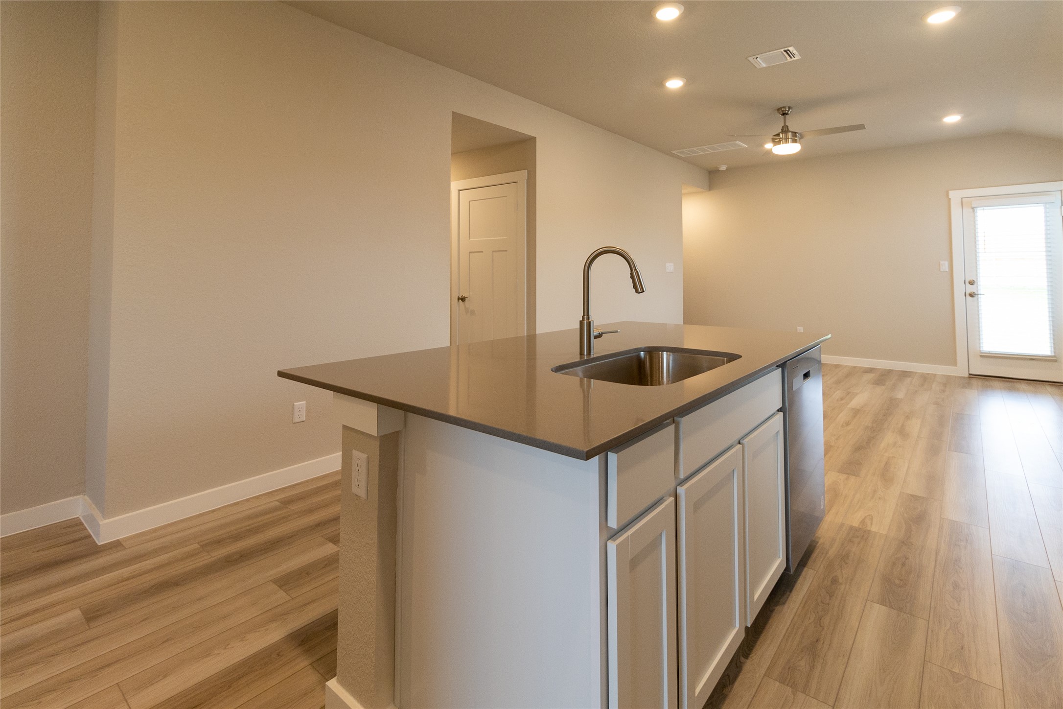 325 Coda Crossing Georgetown, TX 78633 - Photo 9 of 24 a kitchen that has a sink and a wooden floor