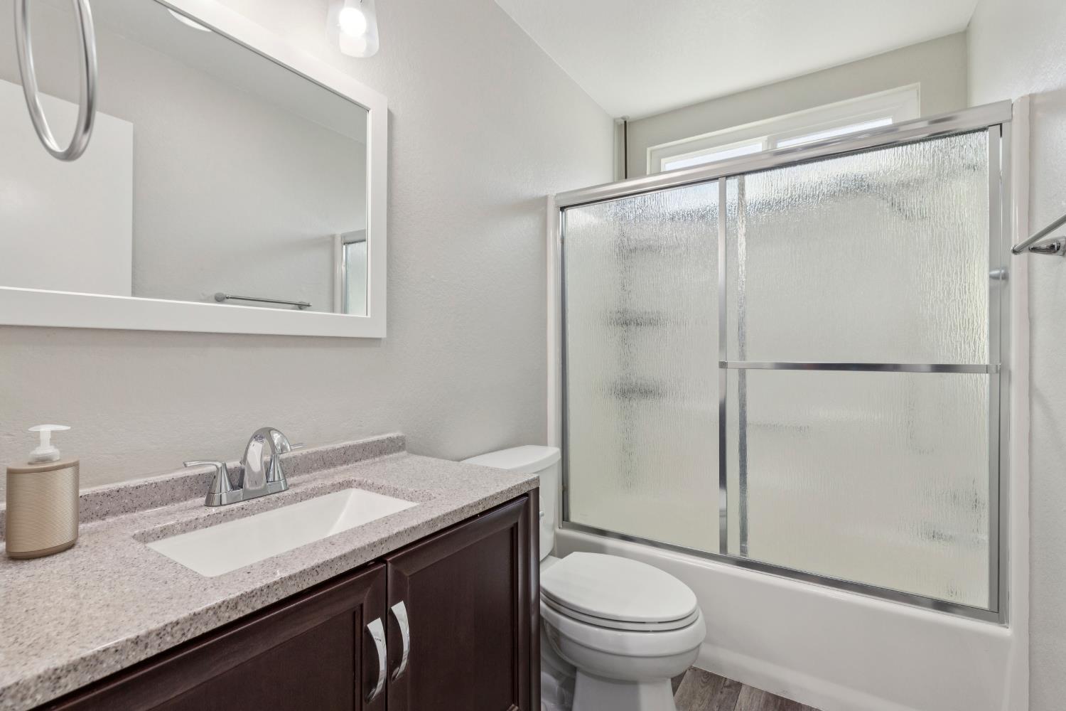2612 Star Oak Court Modesto, CA 95355 - Photo 12 of 26 a bathroom with a granite countertop sink toilet and shower