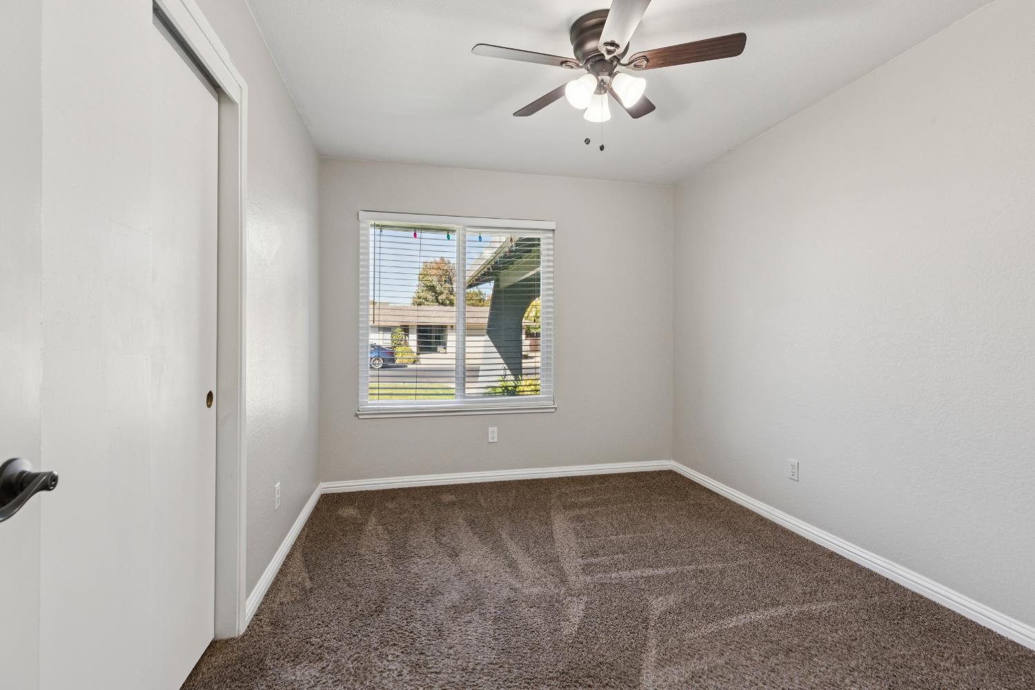 2612 Star Oak Court Modesto, CA 95355 - Photo 14 of 26 an empty room with windows and fan