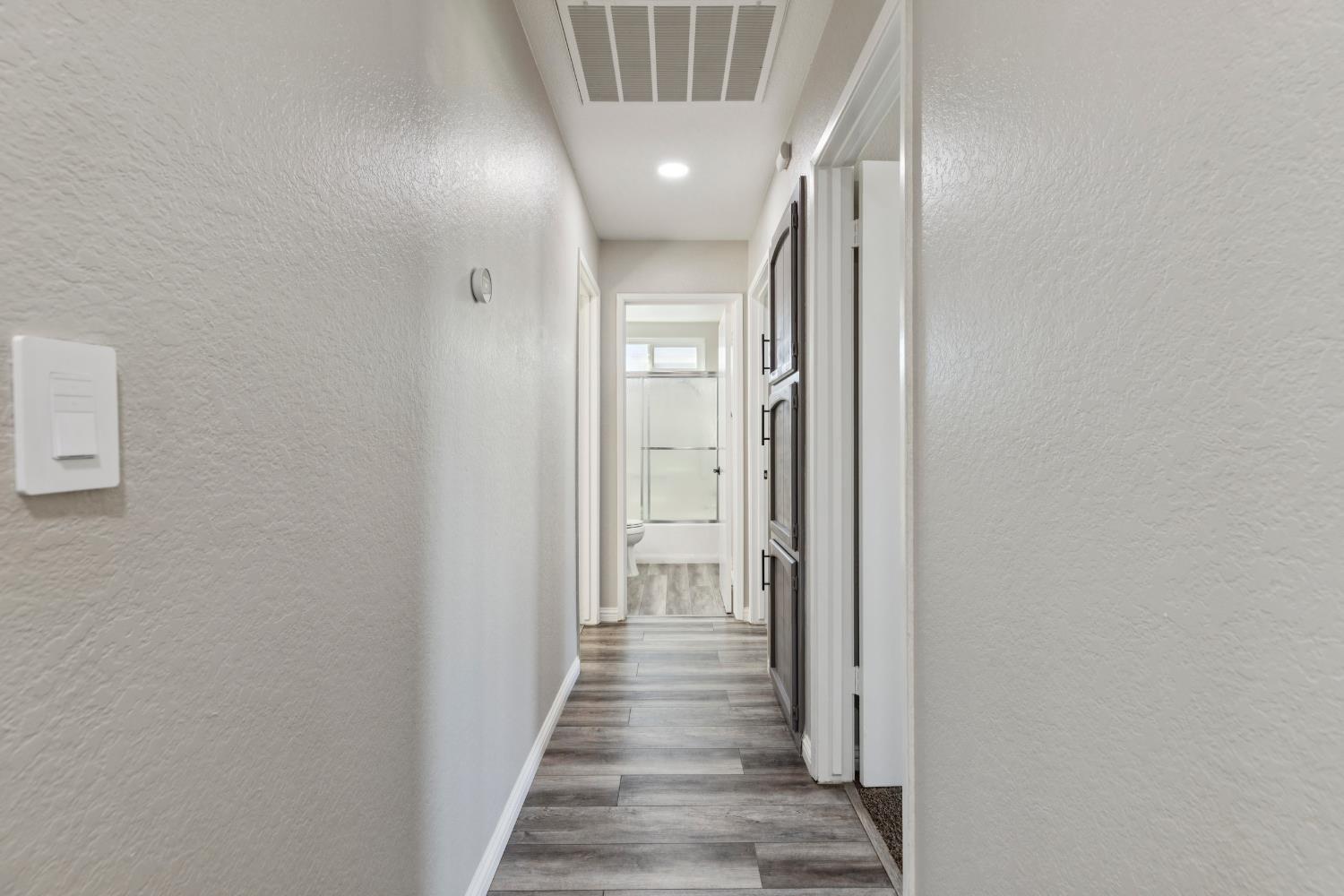 2612 Star Oak Court Modesto, CA 95355 - Photo 15 of 26 a view of a hallway with wooden floor and staircase