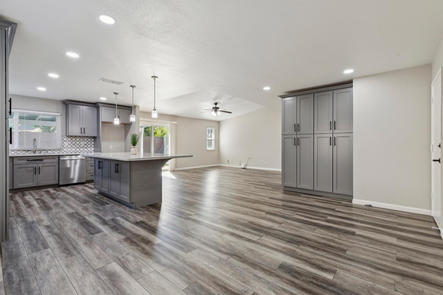 2612 Star Oak Court Modesto, CA 95355 - Photo 17 of 26 a large kitchen with stainless steel appliances granite countertop a large counter top a sink and a refrigerator