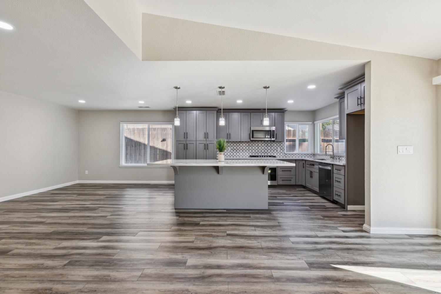 2612 Star Oak Court Modesto, CA 95355 - Photo 19 of 26 a view of kitchen with kitchen island stainless steel appliances refrigerator stove microwave and cabinets