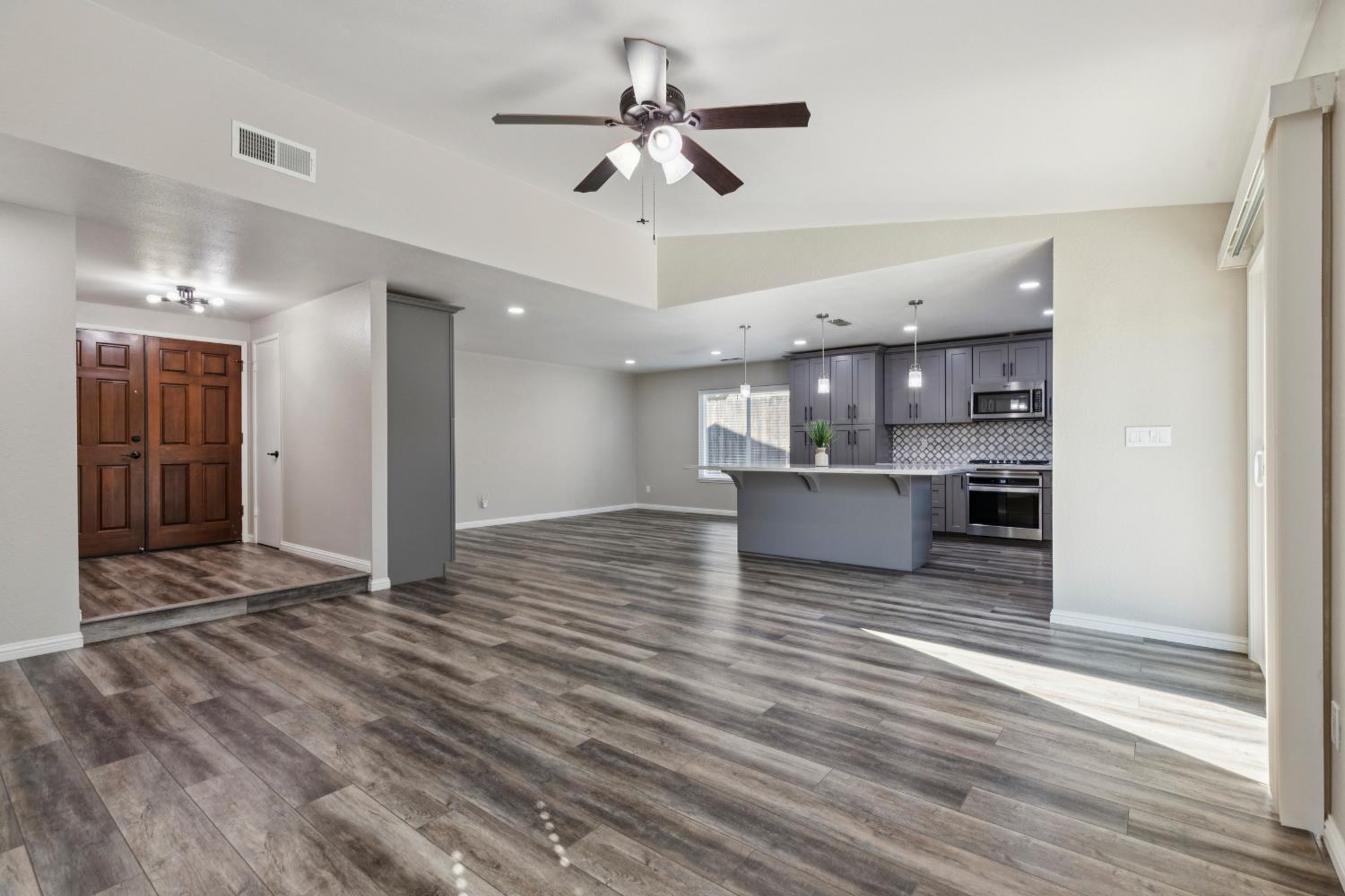 2612 Star Oak Court Modesto, CA 95355 - Photo 23 of 26 a view of a kitchen with wooden floor and a ceiling fan