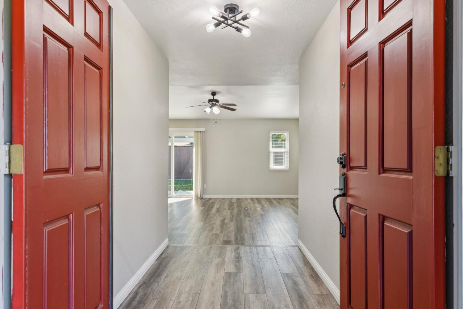 2612 Star Oak Court Modesto, CA 95355 - Photo 25 of 26 a view of a hallway with wooden floor and staircase