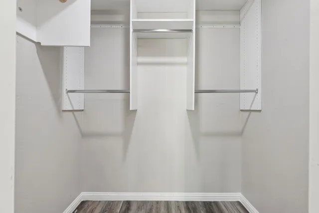 a view of walk in closet with empty racks