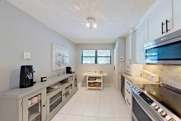 a kitchen that has a lot of cabinets in it