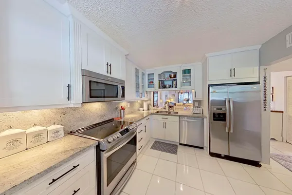 a kitchen with a sink stove and refrigerator