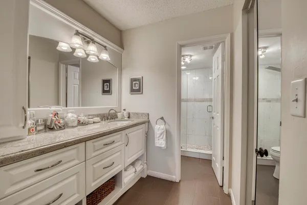 a bathroom with a double vanity sink and a mirror