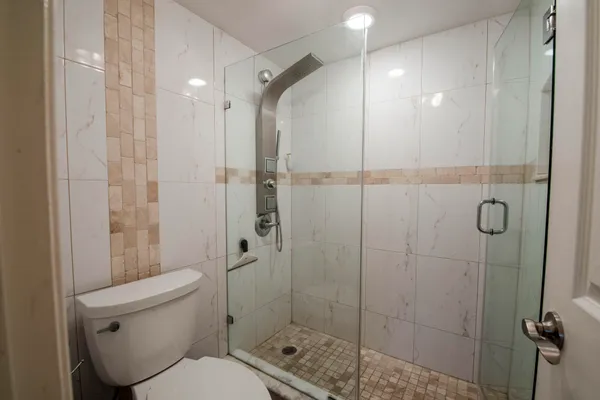 a bathroom with a toilet and shower