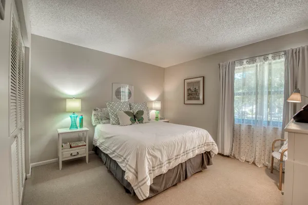 a bedroom with a bed and a table