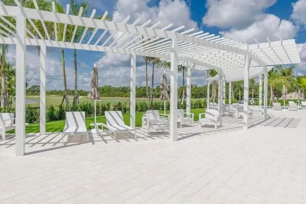 a view of small building with porch and a patio