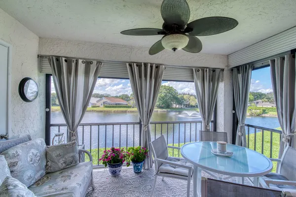 a dining room with furniture a flat screen tv and a large window