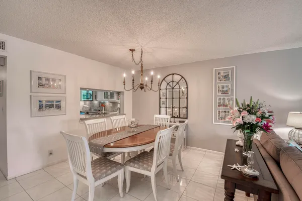 a view of a dining room with furniture and a chandelier