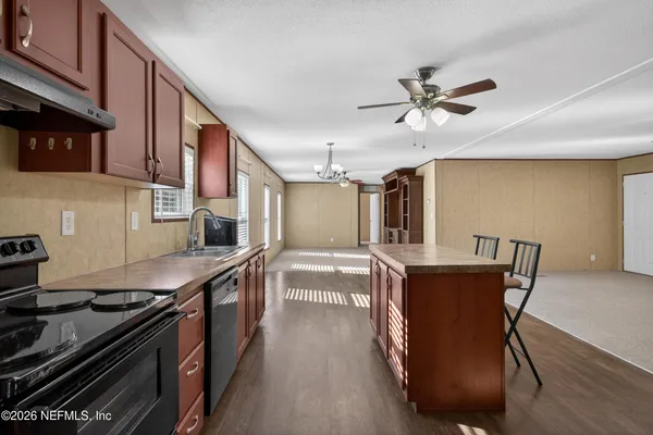 a kitchen with stainless steel appliances granite countertop a stove a sink dishwasher and a refrigerator