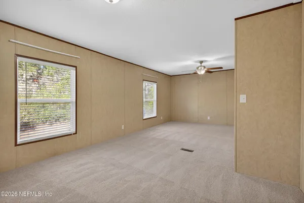 an empty room with windows and closet