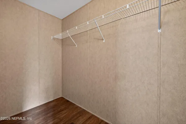 a view of a room with wooden floor