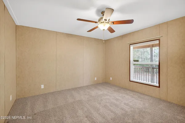 a view of an empty room with a window