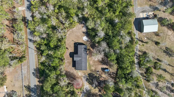 an aerial view of a house with a yard