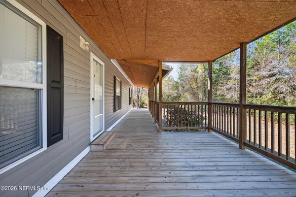 a view of a balcony with wooden floor