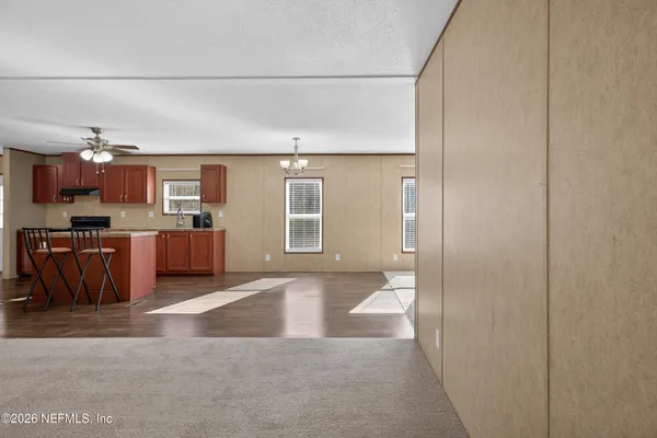 a view of kitchen with furniture and wooden floor