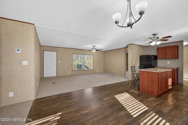 a bedroom with furniture a chandelier and wooden floor