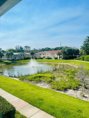 a view of a lake with houses in the back