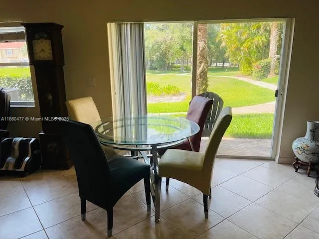 a view of a dining room with furniture and a window