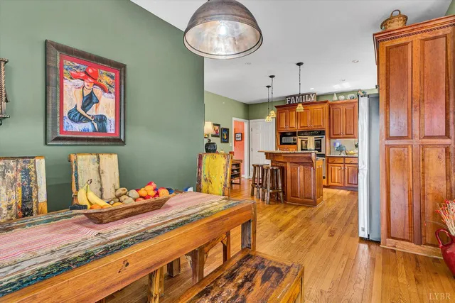 a living room with furniture dining table and a wooden floor