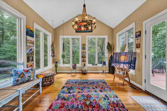 a living room with furniture a flat screen tv and a large window