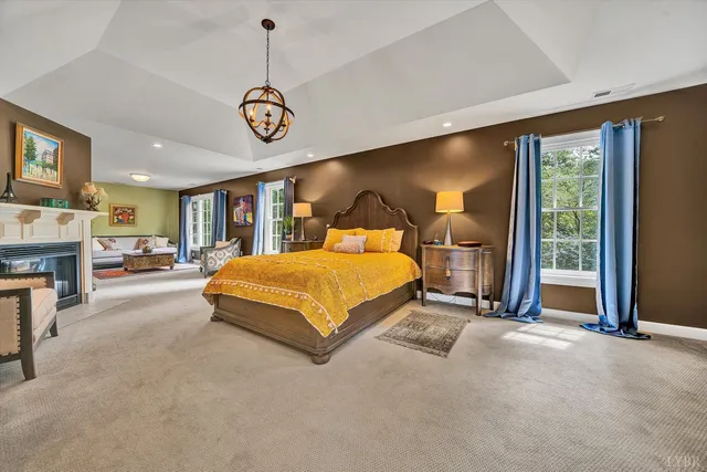 a bedroom with a bed a couch and dresser