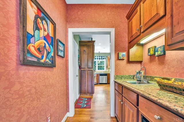 a kitchen with counter top space and wooden floor