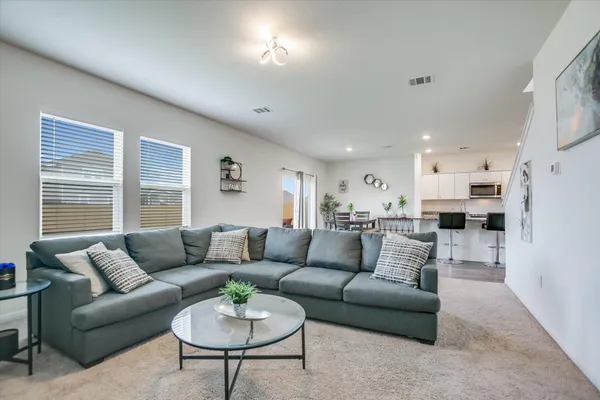 a living room with furniture and a large window
