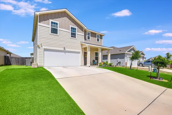 a front view of a house with a yard and garage
