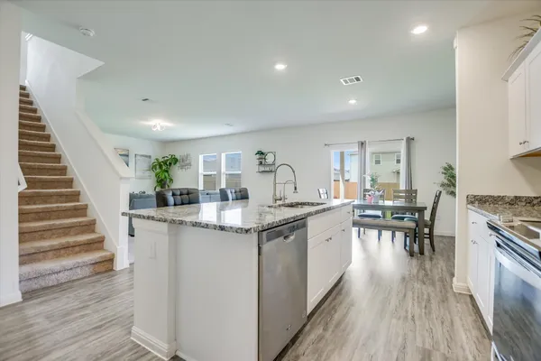 a kitchen with counter top space and wooden floor