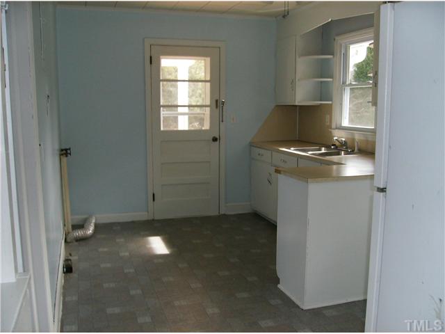 832 Clay Thomas Road Roxboro, NC 27573 - Photo 8 of 13 a kitchen with a stove and a refrigerator