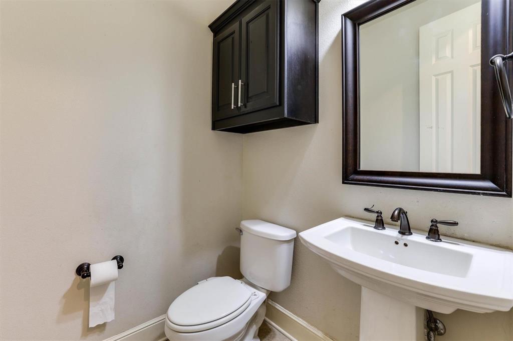 419 Rio Grande Drive Irving, TX 75039 - Photo 7 of 29 Pedestal sink with dark bronze fixtures and a coordinating framed mirror