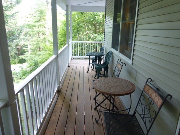 36 Torrey Street Easthampton, MA 01027 - Photo 5 of 20 a view of a balcony with furniture and wooden floor